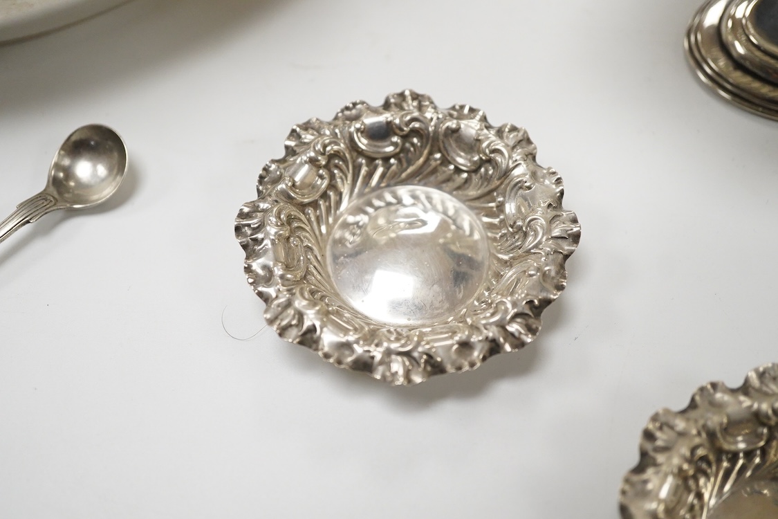 A late Victorian silver boat shaped sugar basket, by Thomas Bradbury & Sons, London, 1896, length 13.2cm, together with a pair of late Victorian repousse silver nut dishes and a silver condiment spoon. 4.8oz.